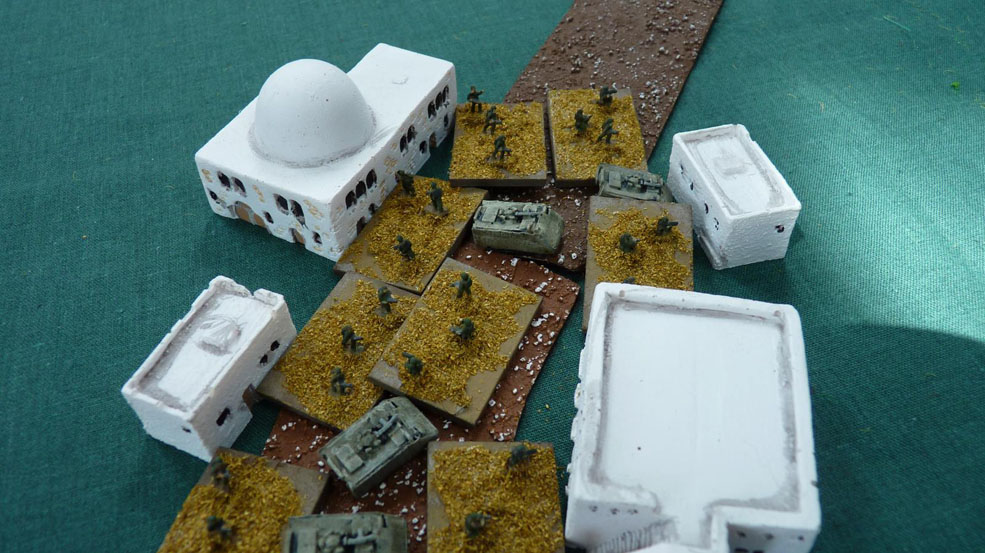 Infantry leaves their carriers in a hamlet